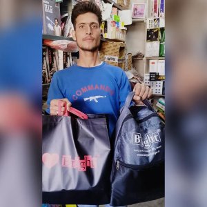 Happy Retailer With Branded Bag and Backpack