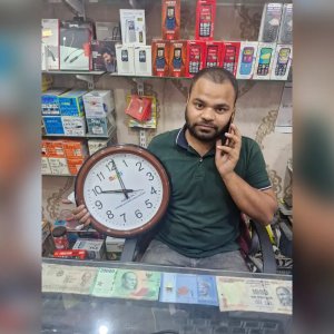Shop Owner Holding Branded Wall Clock